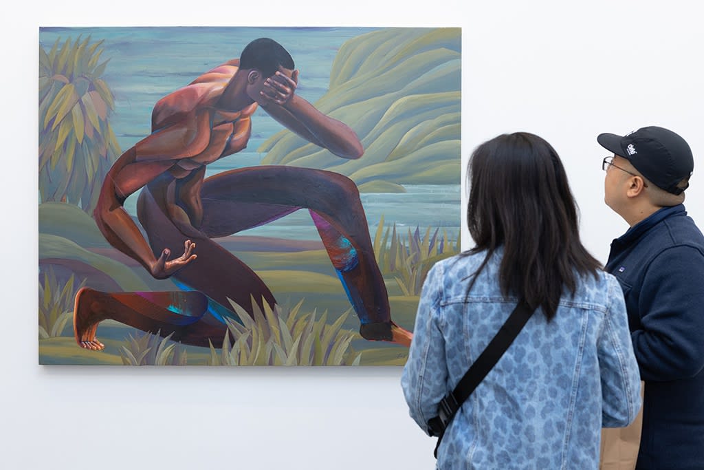 Two people look at Erik Jones's painting 
