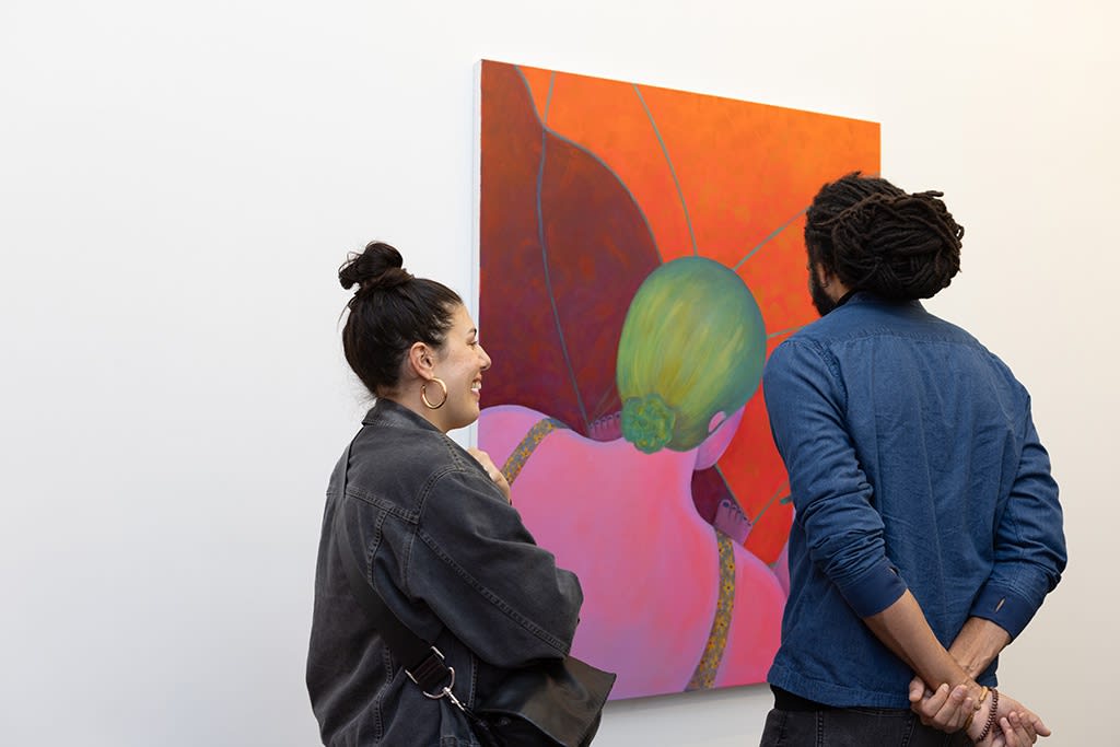 two people looking at a Geneveive Cohn painting