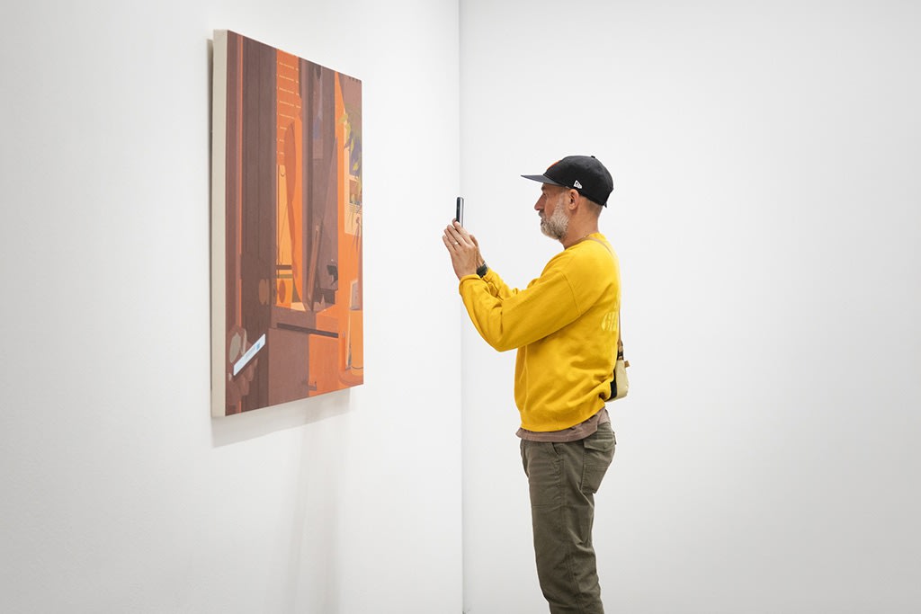Image of a visitor looking intently at a painting by artist Adrian Kay Wong at the opening reception of his latest exhibition