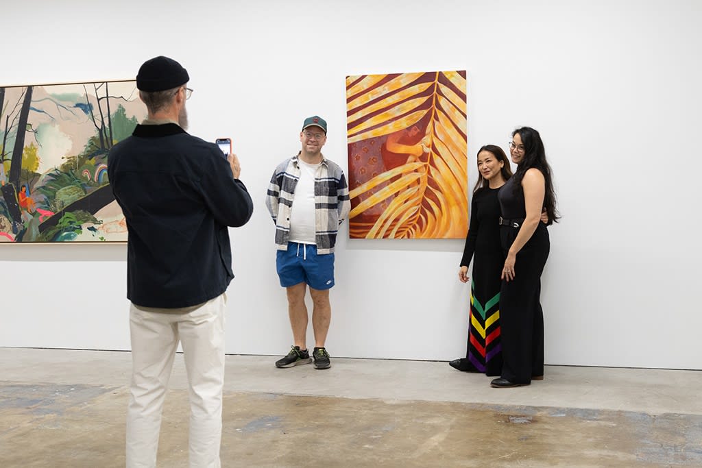 Hashimoto Contemporary Partner Dasha Matsuura, Founder/Curator of the Jaunt Jeroen Smeets, and artist Seonna Hong pose in front of Genevieve Cohn's painting 