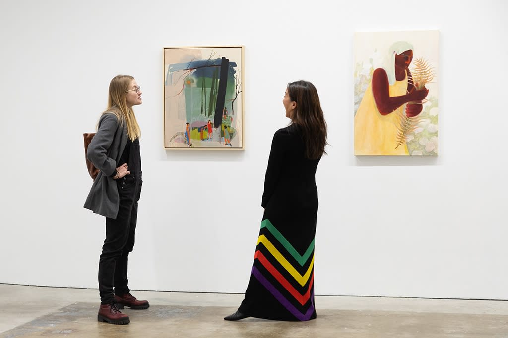 artist seonna hong chatting with a visitor in front of her work at the Jaunt: Winter Camp opening reception at Hashimoto Contemporary San Francisco