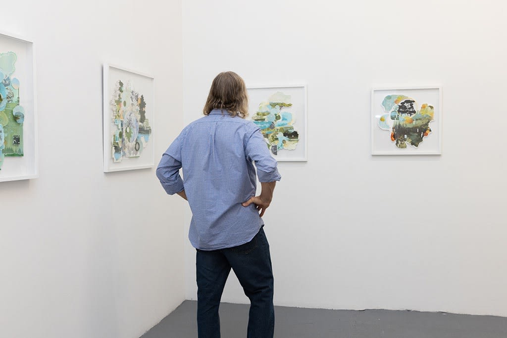 Man standing at the opening of Gregory Euclide's Assembled Lands