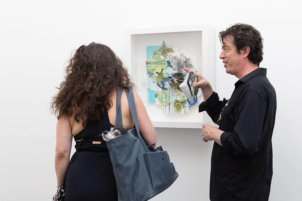 people chatting and a dog at the opening of Gregory Euclides 