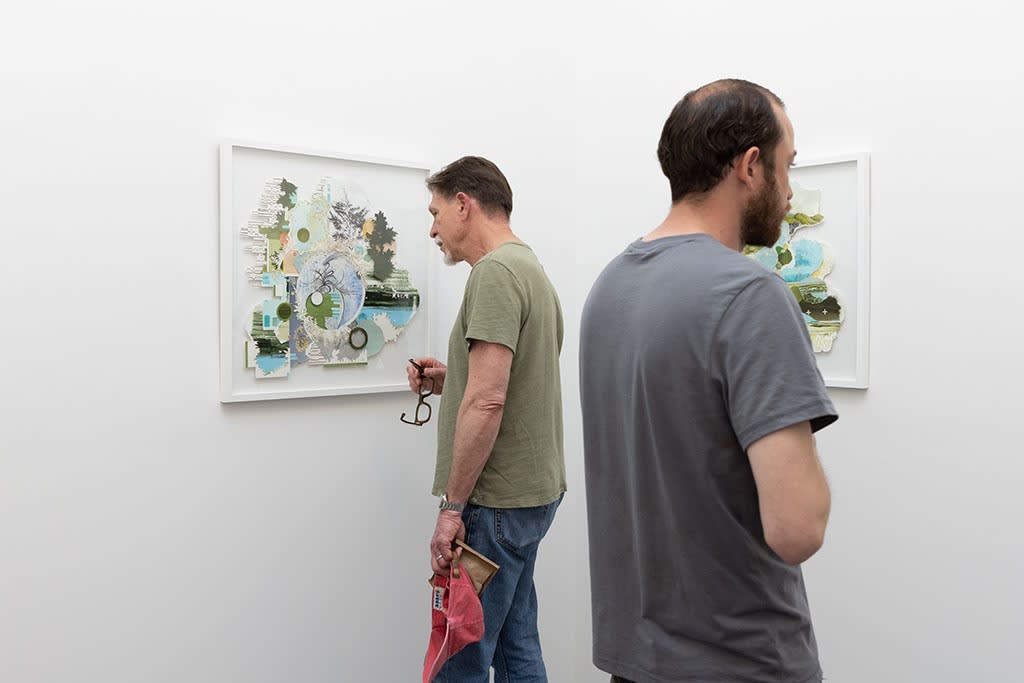 People looking at art at the opening of Gregory Euclide's Assembled Lands