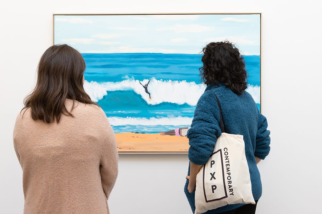 Visitors look at Jean Jullien's painting on a white wall. 
