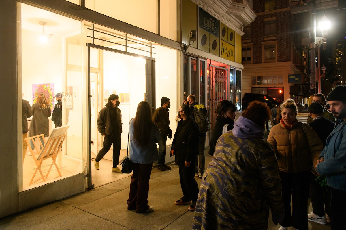 photo of a gallery patron in front of Dennis Browns artwork