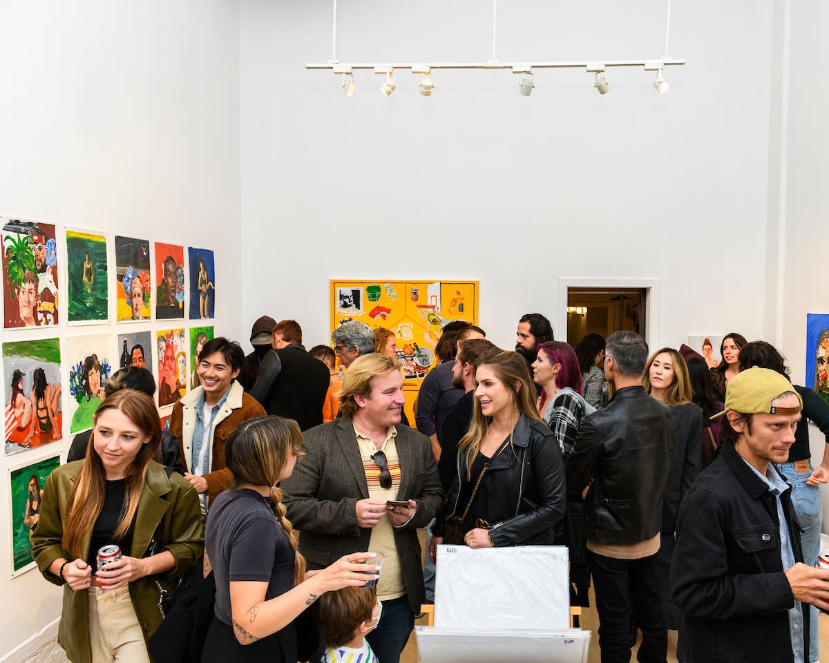 Opening reception photo of people looking at the artwork