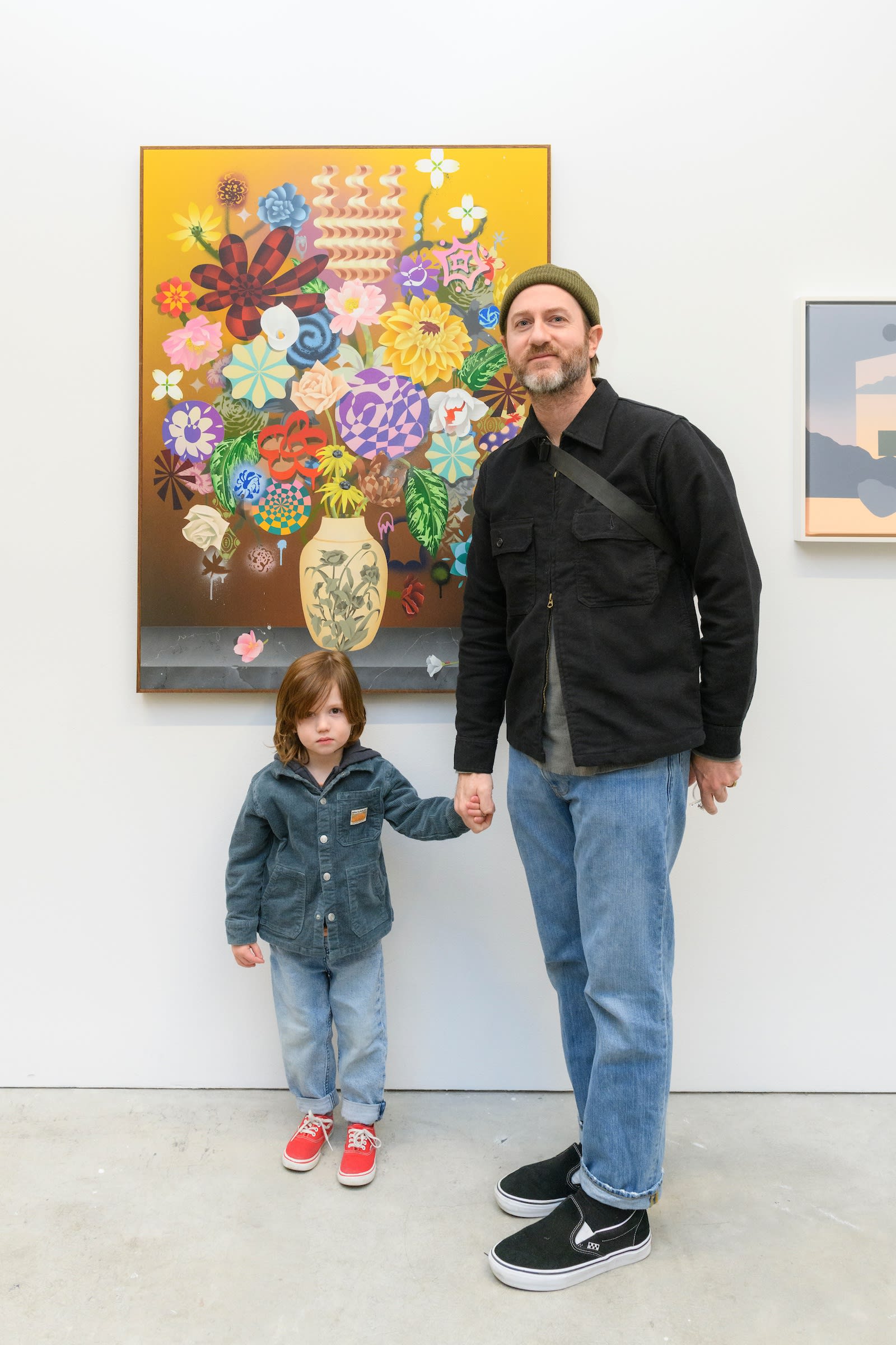Artist Casey Gray taking a photo of his son infront of his piece at Hashimoto San Francisco 