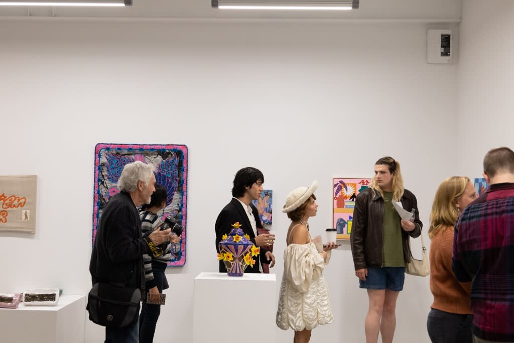 People mingle at the openign reception of Devra Fox's solo exhibition In Orbit. 