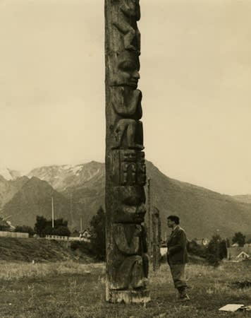 Kurt Seligmann in front of a Gitksan Totem Pole, British Columbia, 1938.