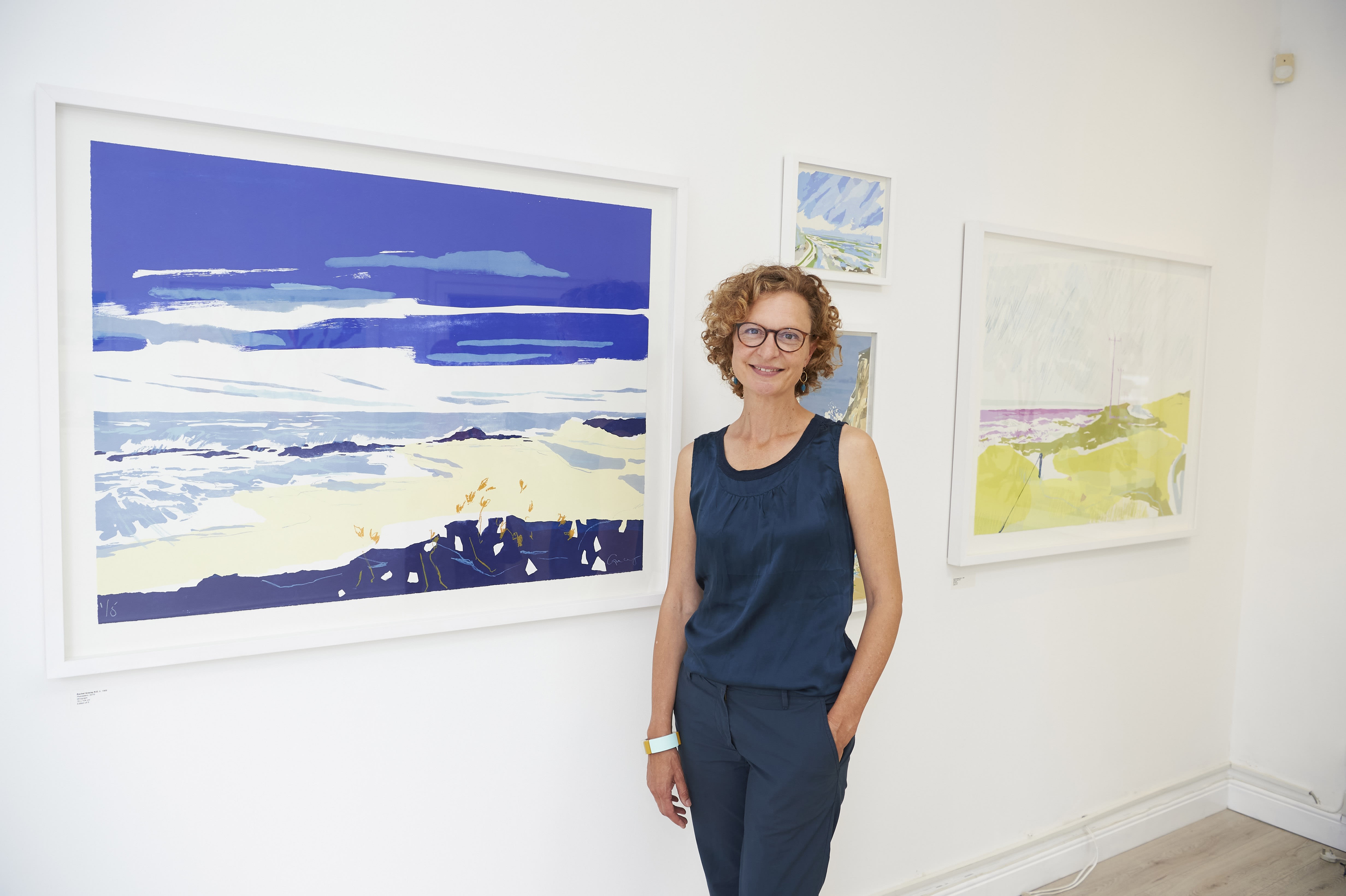 Rachel Gracey in front of her exhibition series 'The Pacific Coast'