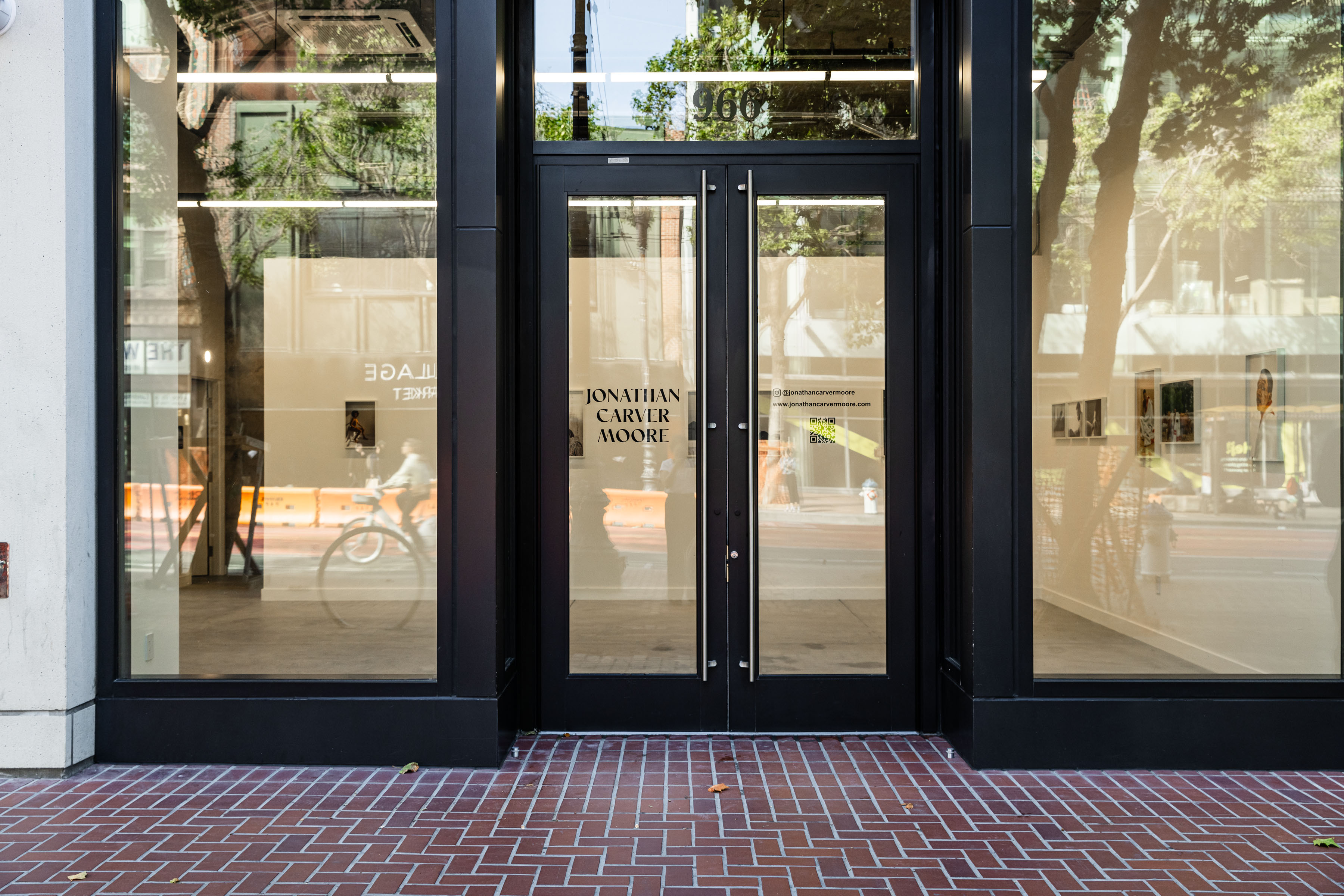 Black-framed glass storefront with Jonathan Carver Moore gallery name on entrance doors.