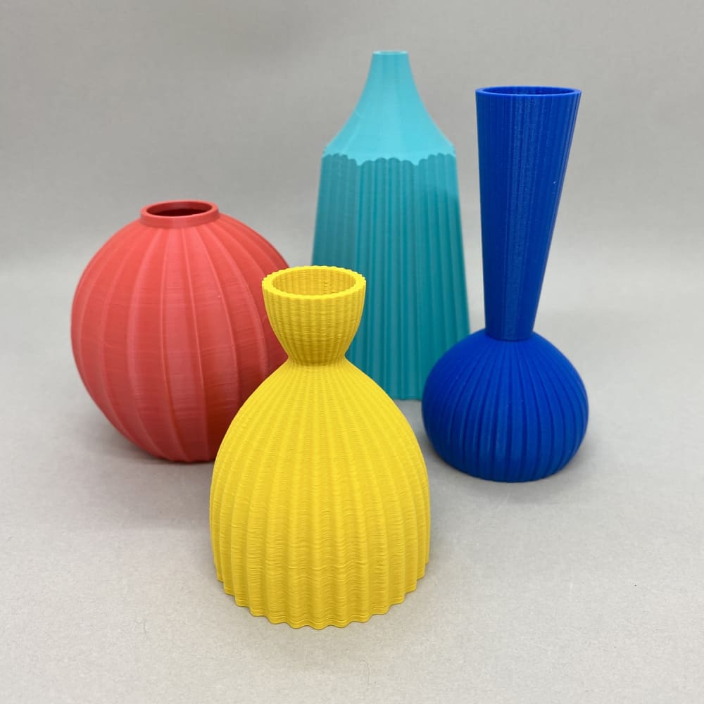 Keeley Traae 4 3D printed pots stood in a diamond cluster, in Rhubarb, Aqua, Custard and Electric.