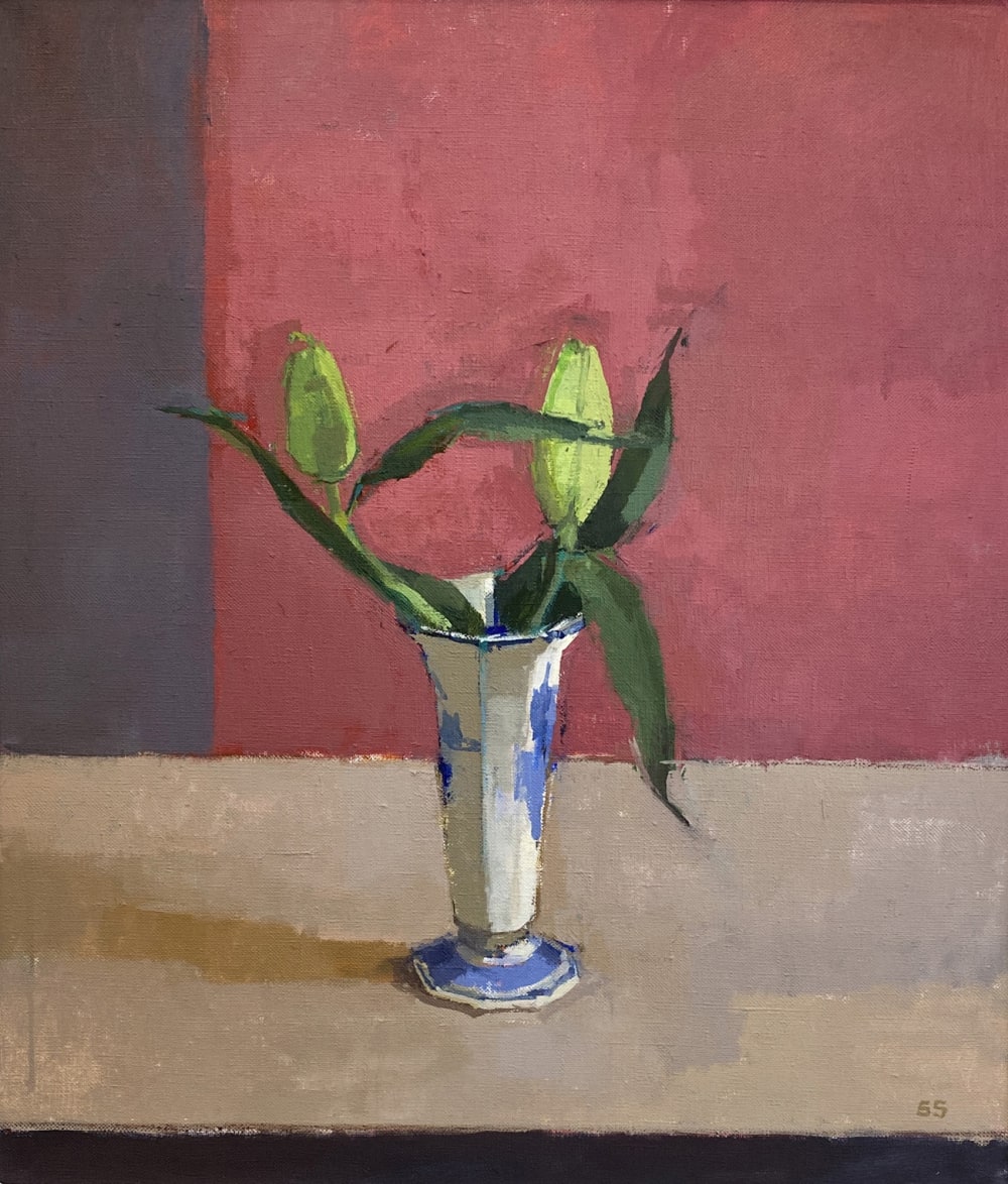 A still life painting of two flower buds in a blue and white vase set against a deep pink background