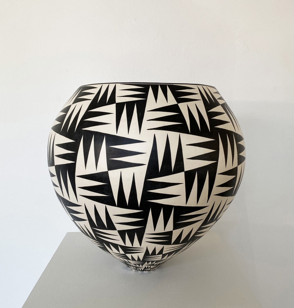 Tydd Pottery wide, round ceramic black and white vessel with complex diagonal line patterns around it.