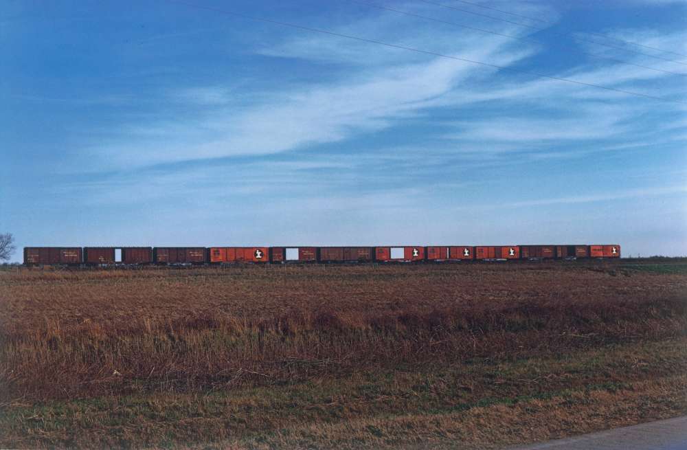 William Eggleston, Train Cars in Field, from the Southern Suite Portfolio, 1971