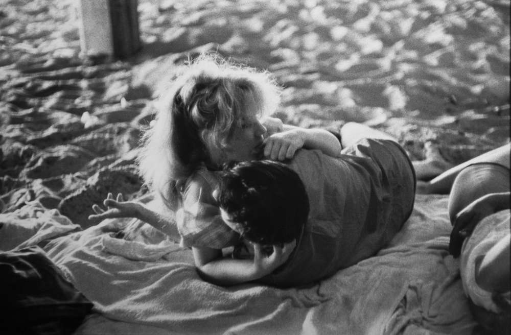 Bruce Davidson, Brooklyn Gang (couple embracing on blanket under boardwalk), 1959