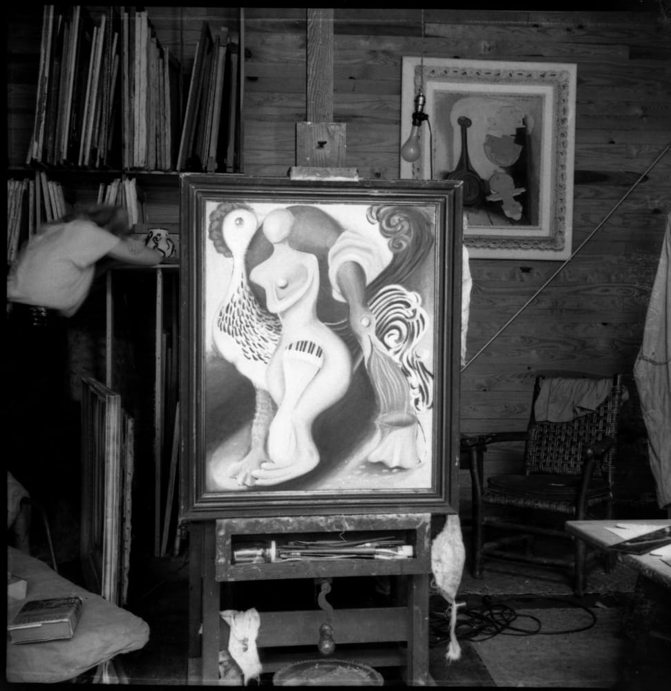 Dusti Bongé in her studio with her painting Untitled (Figure with Piano Keys and Rooster) or Circus (1938), circa 1940s, courtesy of the Dusti Bongé Art Foundation