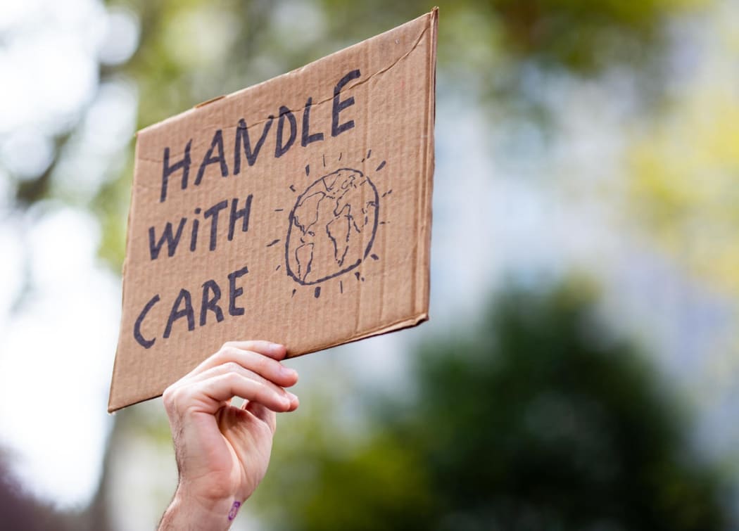 'Handle with care' cardboard sign