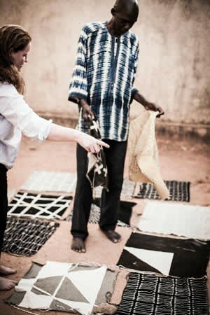 Rebecca Hoyes, of Habitat, and designer Boubacar Doumbla make cushions in Mali. Image courtesy of the Financial Times.