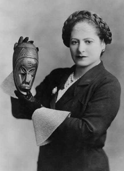 Helena Rubinstein with African mask, c. 1935. Image courtesy of the Helena Rubinstein Foundation archive, Fashion Institute of Technology, State University of New York, Special Collections. Photograph by George Maillard Kesslere.