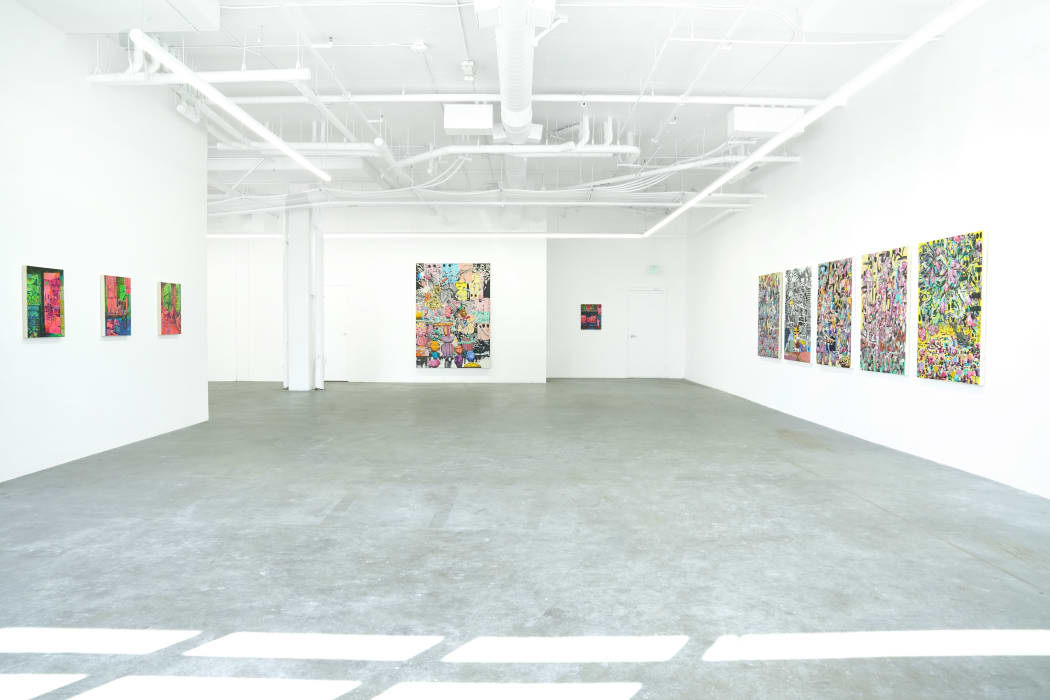 installation view of the gallery with an array of paintings on the wall by Carlson Hatton