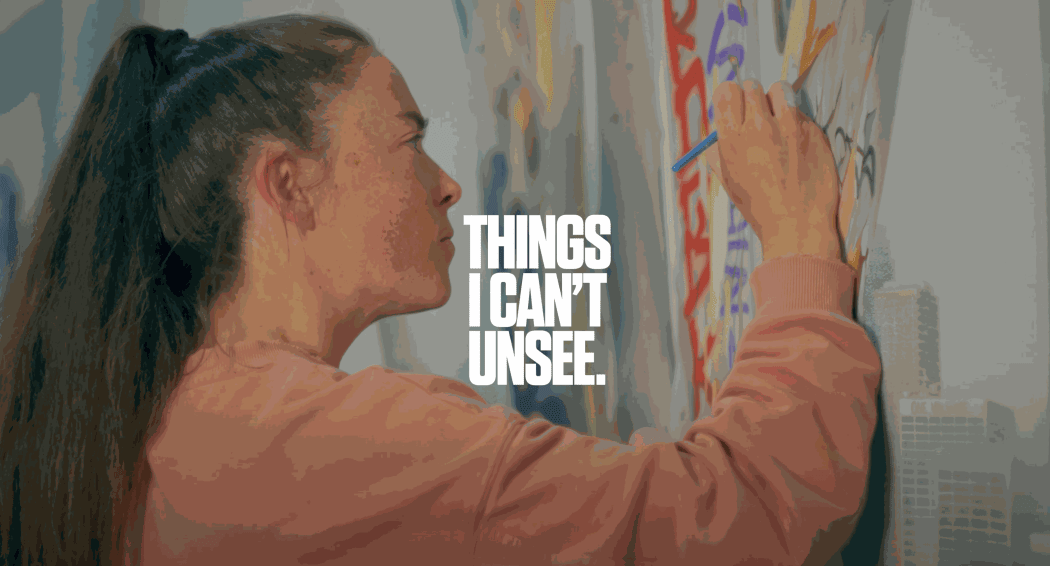 photo of the artist, Adele Renault, painting on a canvas