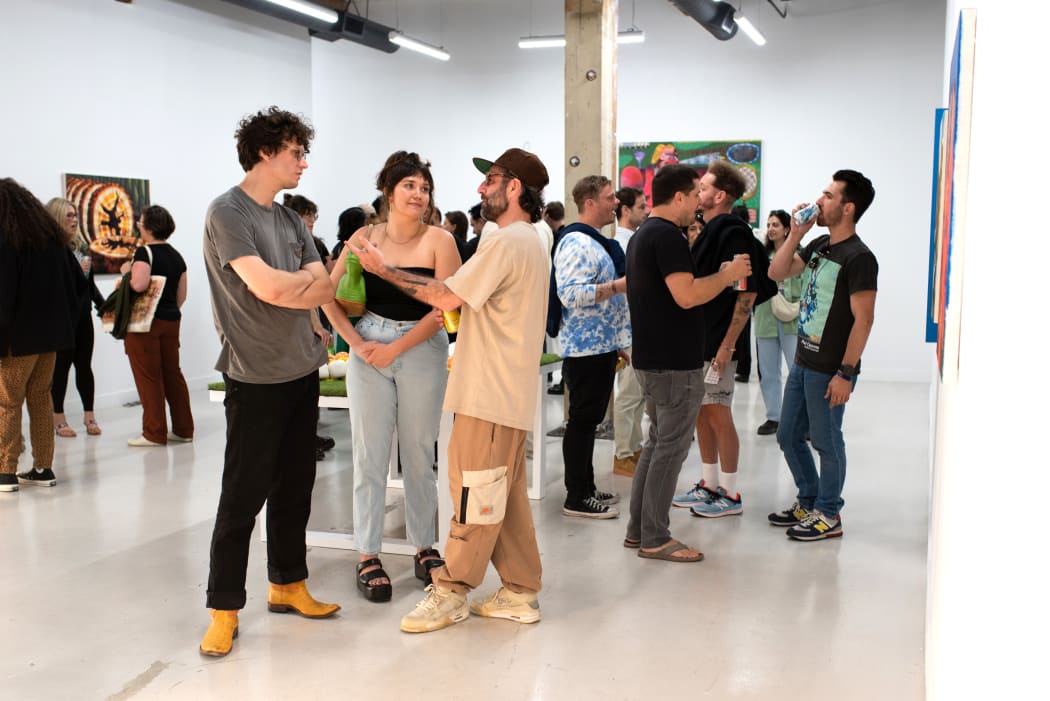 photo of a crowd of people in an art gallery