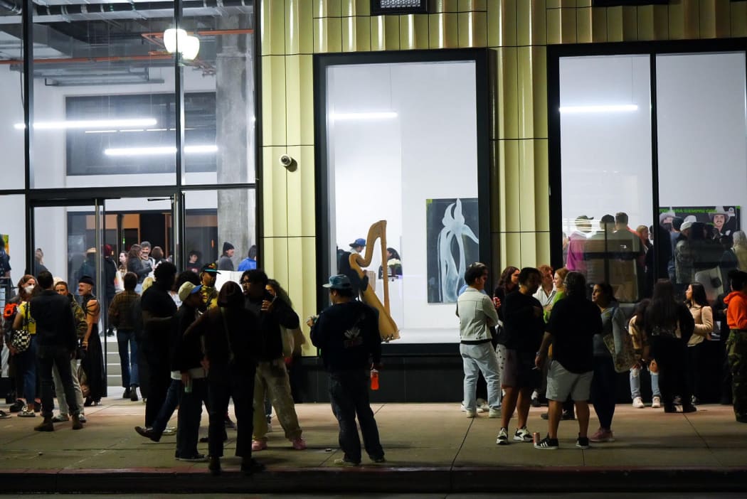 photo of the gallery from the outside with a crowd standing in front