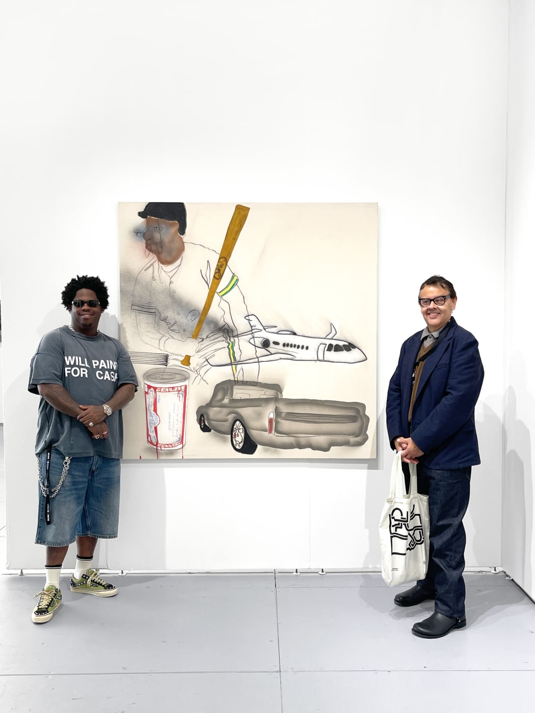 photo of the artist next to their painting