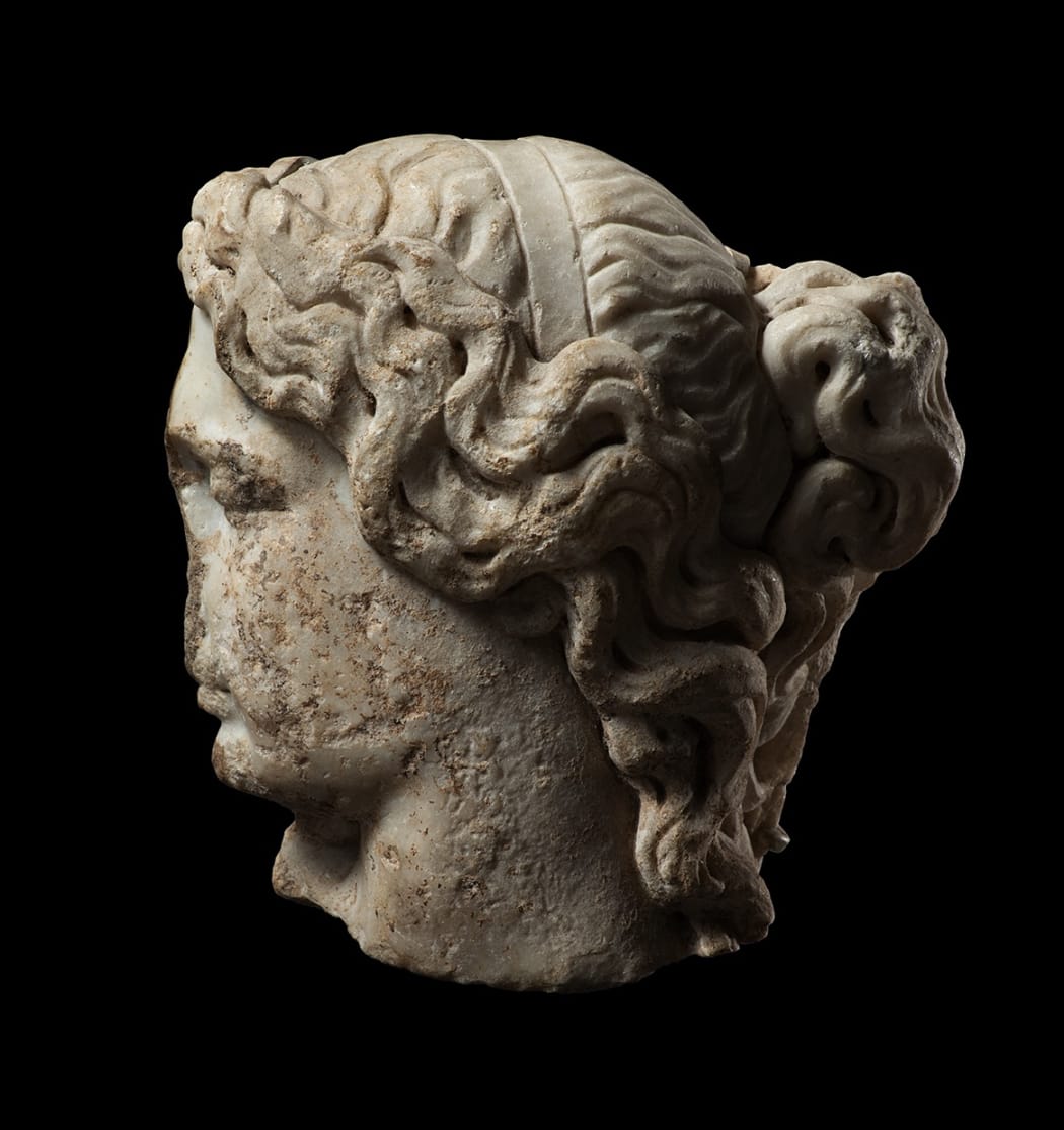 A ROMAN MARBLE FRAGMENTARY HEAD OF A SLEEPING WOMAN, Circa 2nd century AD