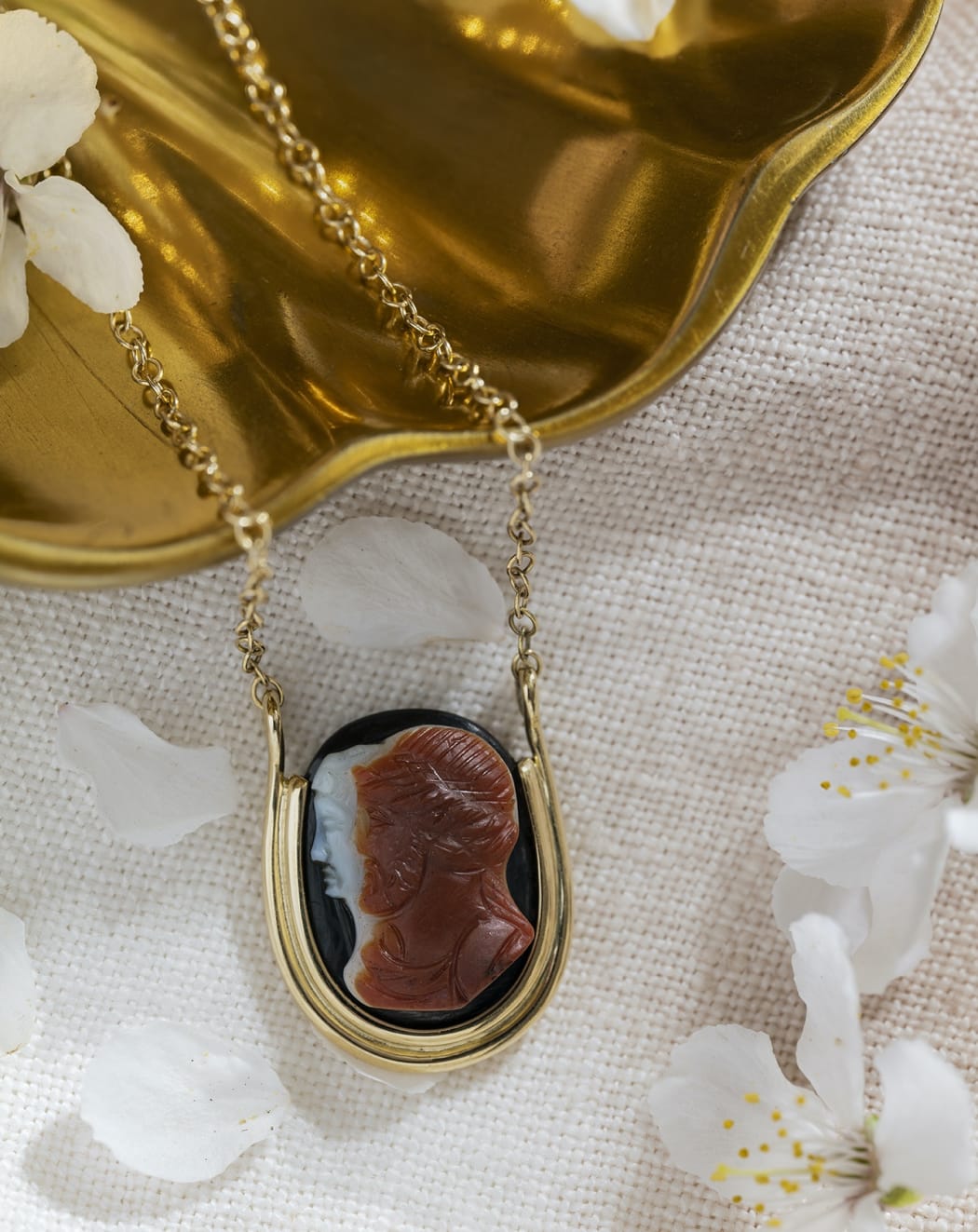 A Roman sardonyx cameo of jugate busts of Zeus and Hera, set in an 18ct gold pendant necklace. Circa 1st - 2nd century AD