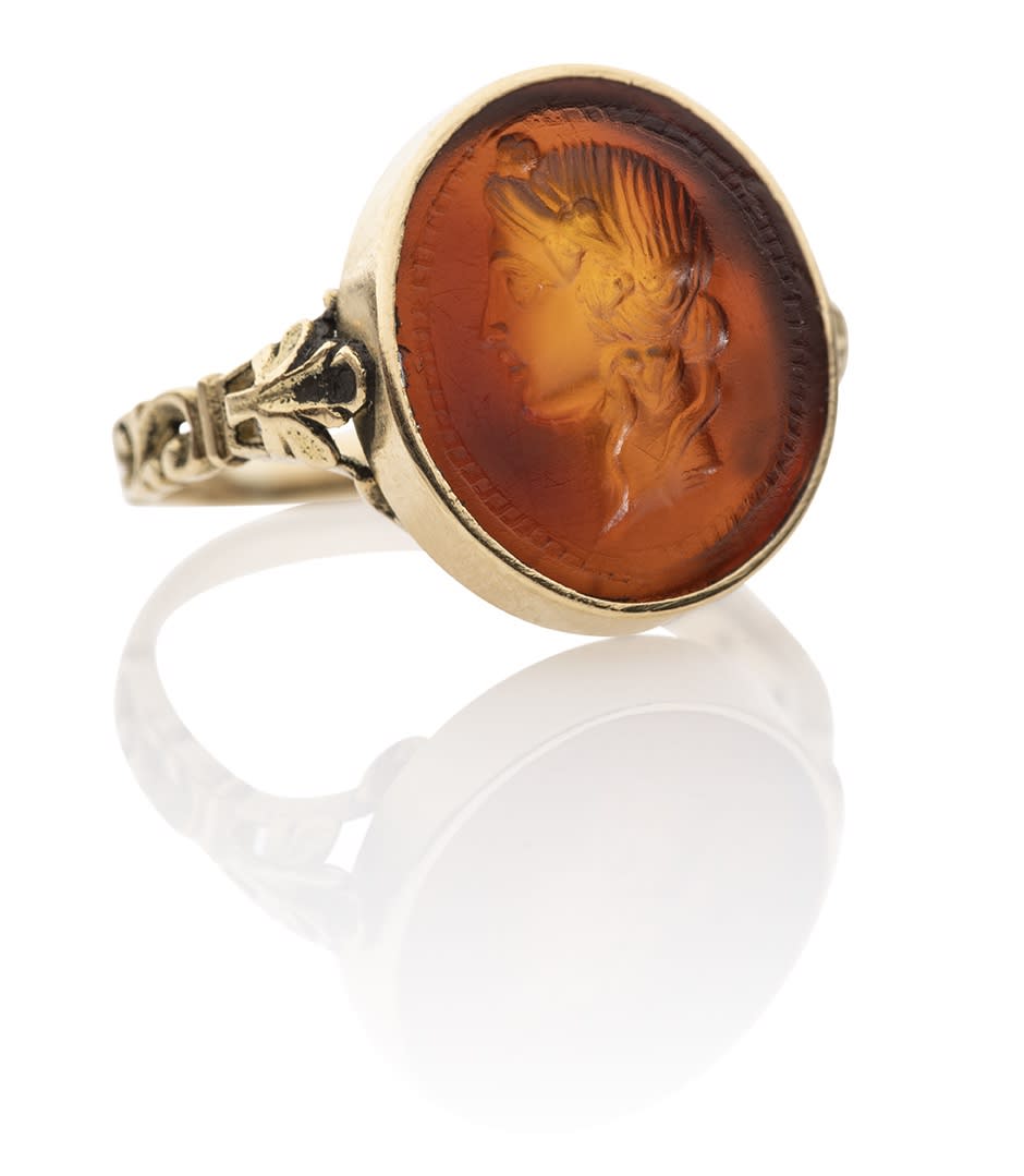 ROMAN CARNELIAN INTAGLIO OF A HEAD OF DIONYSUS, SET IN AN ANTIQUE GOLD RING Republican, circa 1st century AD
