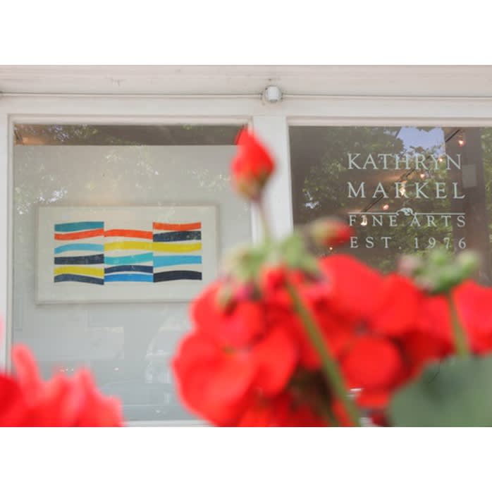 A photograph of Kathryn Markel Fine Arts' Bridgehampton location with a watercolor painting by Kim Uchiyama on display. It was shot behind red roses.
