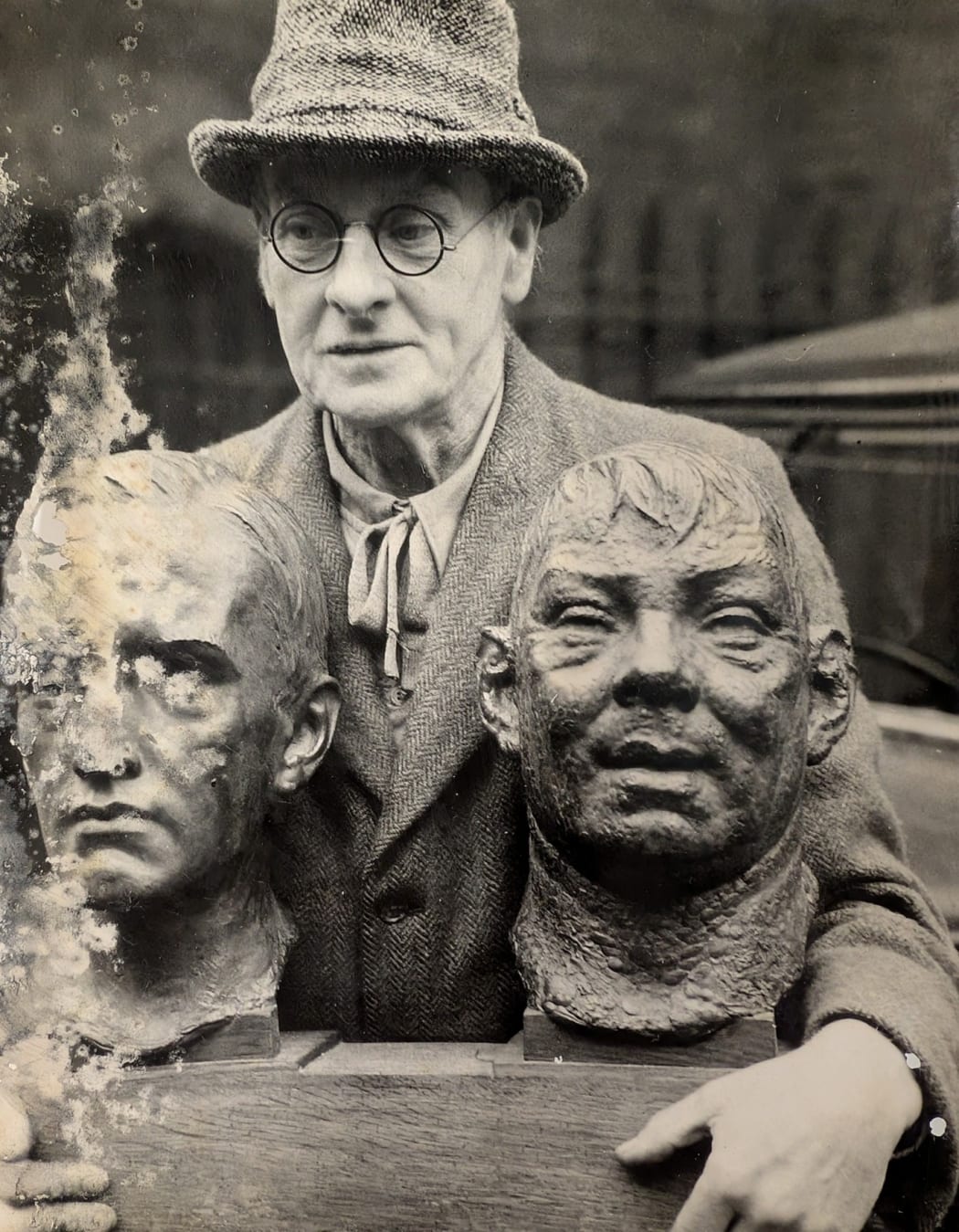 Percy Portsmouth RSA carrying two of his works