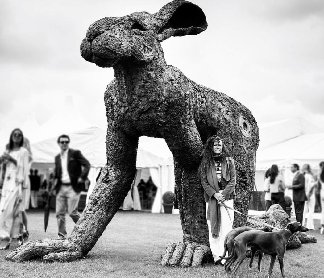 Sophie Ryder in front of her monumental bronze sculpture, Crawling, BRITISH POLO DAY in Henley on Thames.