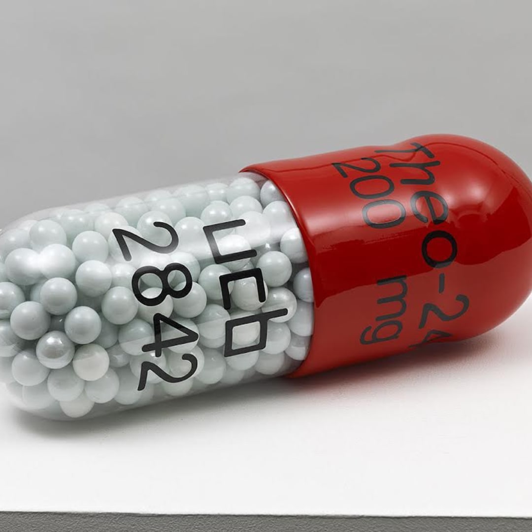 Damien Hirst Theo-24 300mg ucb2852, 2014 Polyurethane resin with ink pigment, PETG vacuum formed shell filled with white glass marbles 12L X 4.25D in. Edition of 30