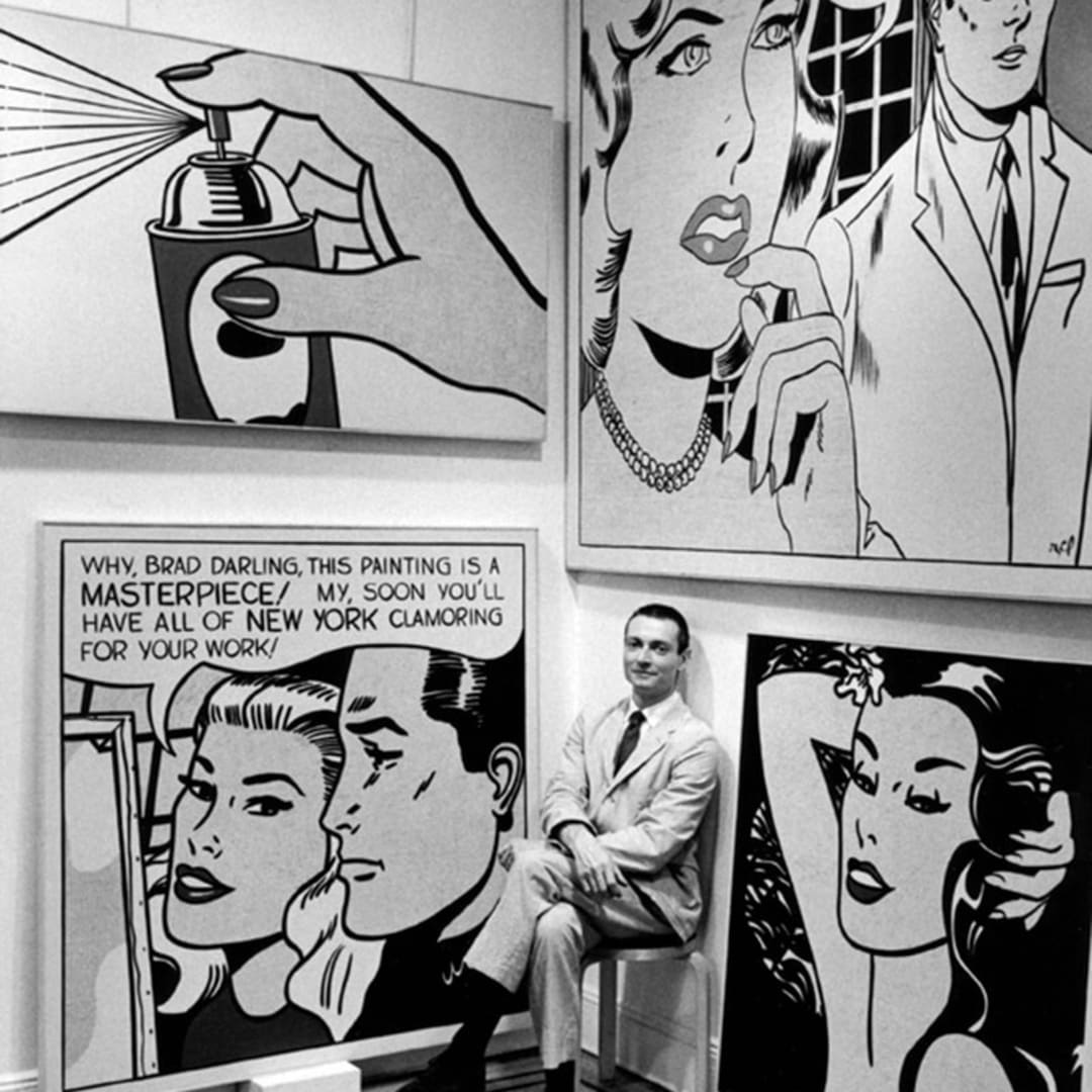 Roy Lichtenstein at Castelli Gallery sitting with Spray (1962), Masterpiece (1962), Engagement Ring (1961) and Aloha (1962), 1962. Photograph by Bill Ray.