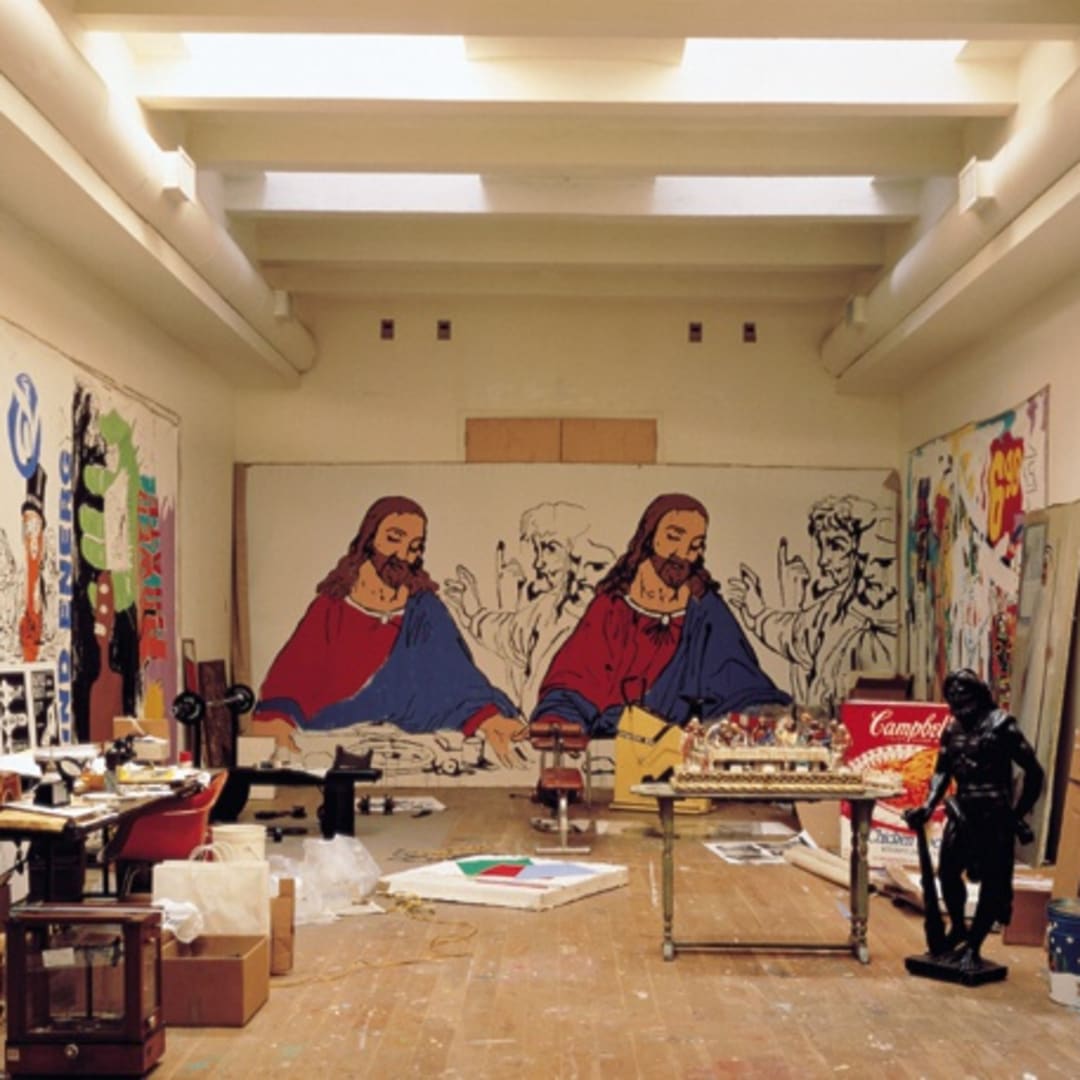 Warhol’s studio with the plastic sculpture of Last Supper sitting on the table in the foreground.
