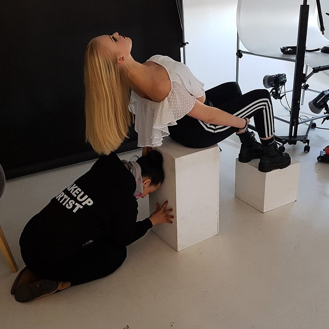 Ideally the model would lie on a table or couch with her head at one end and her hair hanging down freely, not having a suitable table I had to improvise. As you can see the make-up artist is supporting the block she was sitting on
