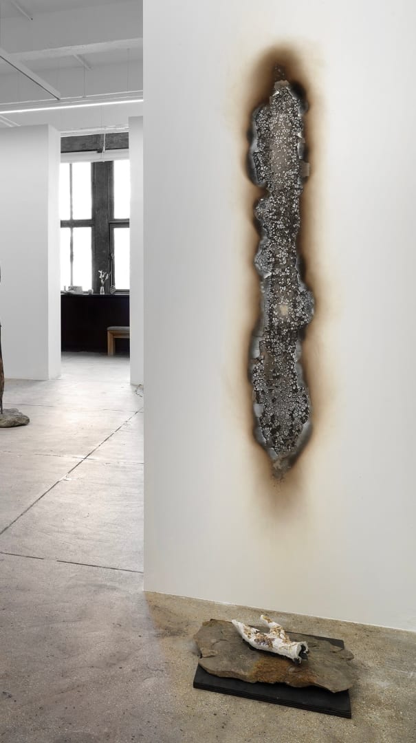 Motohiro Takeda Nights in April , 2024 Cast concrete hand with flowers, found stone, shou sugi ban pedestal, burnt sheetrock 84 x 16 x 24 in 213.4 x 40.6 x 61 cm