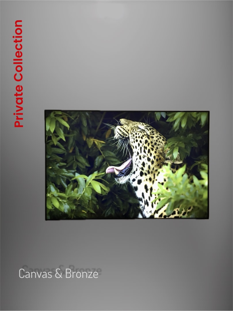 A leopard with its mouth open, partially hidden by lush green foliage, against a dark background.