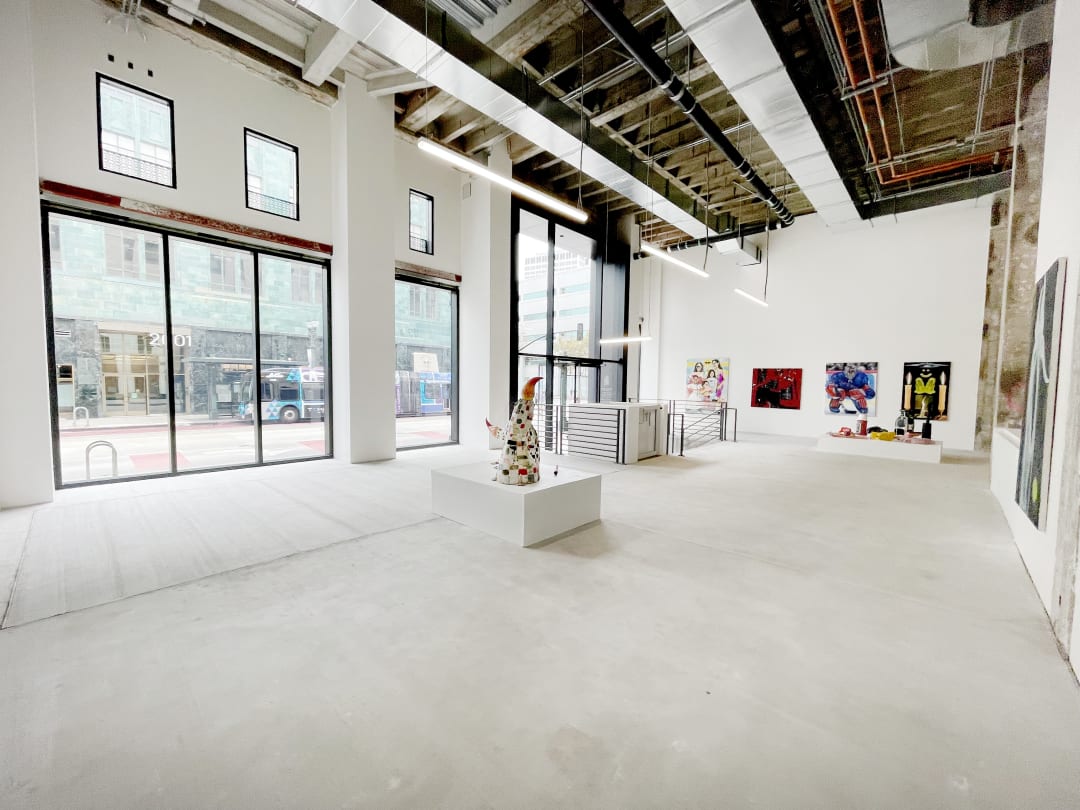 photograph of the gallery with paintings on the walls