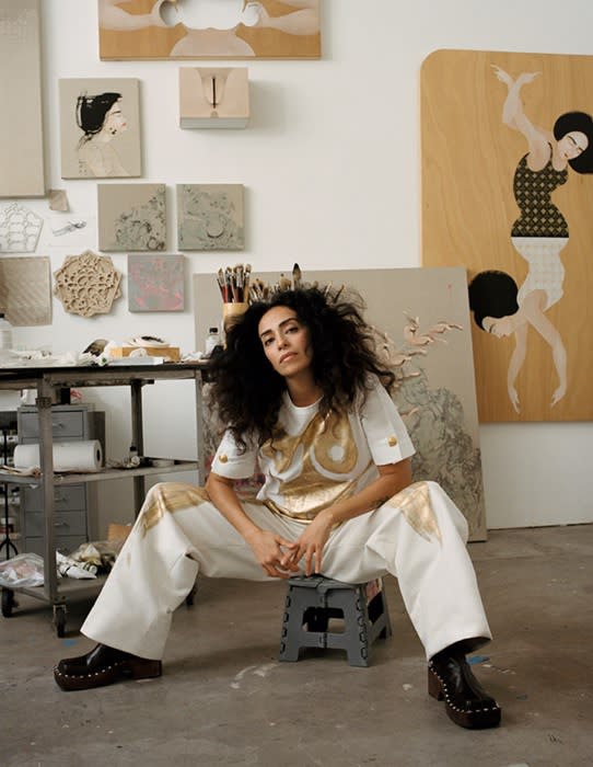 Hayv is wearing a hand-painted T-shirt and trousers in cotton poplin by SCHIAPARELLI. Boots in leather with wooden soles by ACNE STUDIOSPhotography by Daria Kobayashi Ritch, Styling by Alex Assil