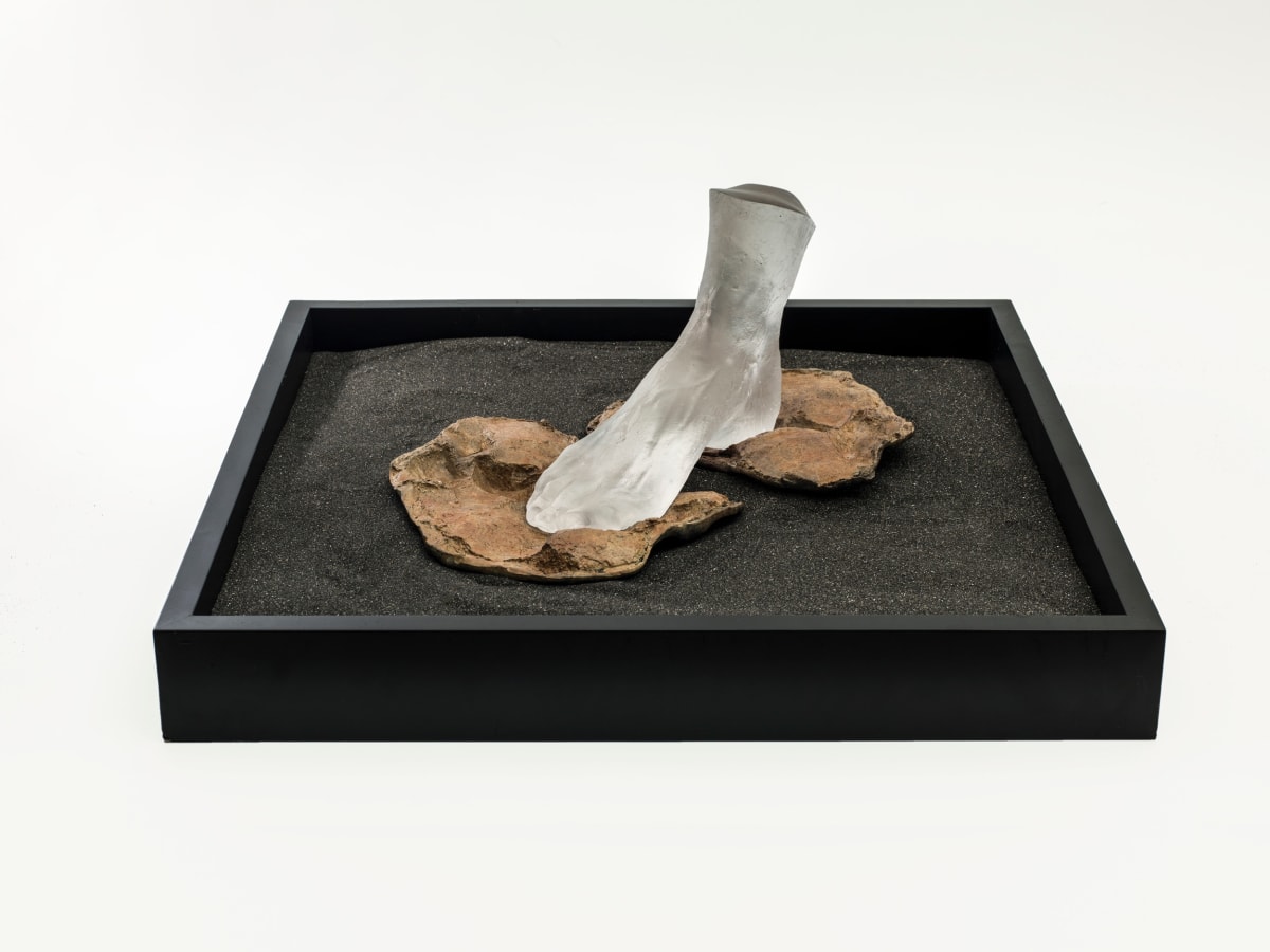 Liliane Lijn Fragile Footing, 2000 Patinated bronze, cast glass, Perspex case, volcanic sand (Ayres Rock stone cast and artist’s foot) 30 x 42 x 42 cm 11 3/4 x 16 1/2 x 16 1/2 in Unique