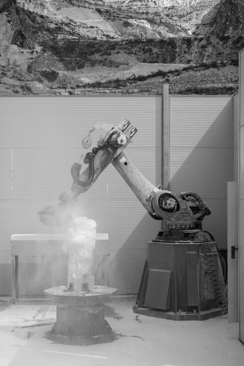 Caleb Stein, Further into the production of artist filippo tincolini  sculpture at robotor with view of carrara mountain behind the working  station view 1 of 6, 2023 | ROSEGALLERY