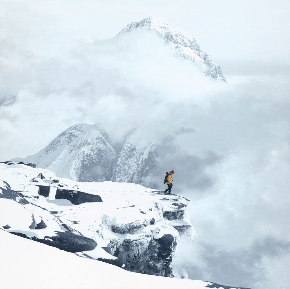 Darren Reid, Lone hiker in a yellow jacket standing on a snowy cliff edge, surrounded by fog-covered mountains and clouds