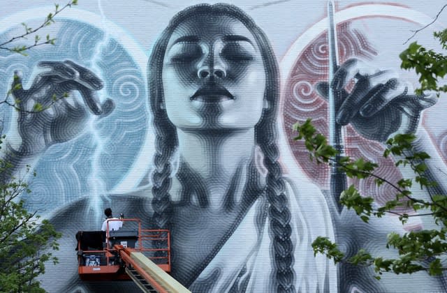 El Mac working on one of his murals.