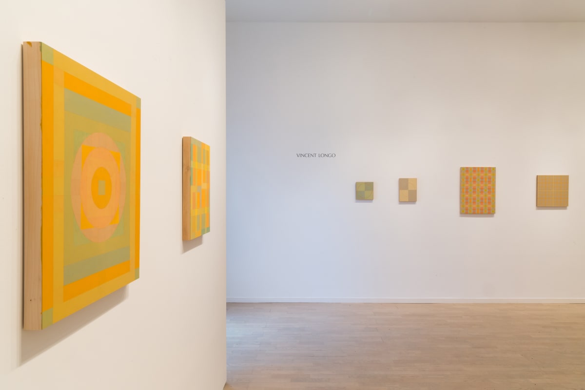 Six geometric warm-hued Vincent Longo's, two on the left wall, and four on the right wall.