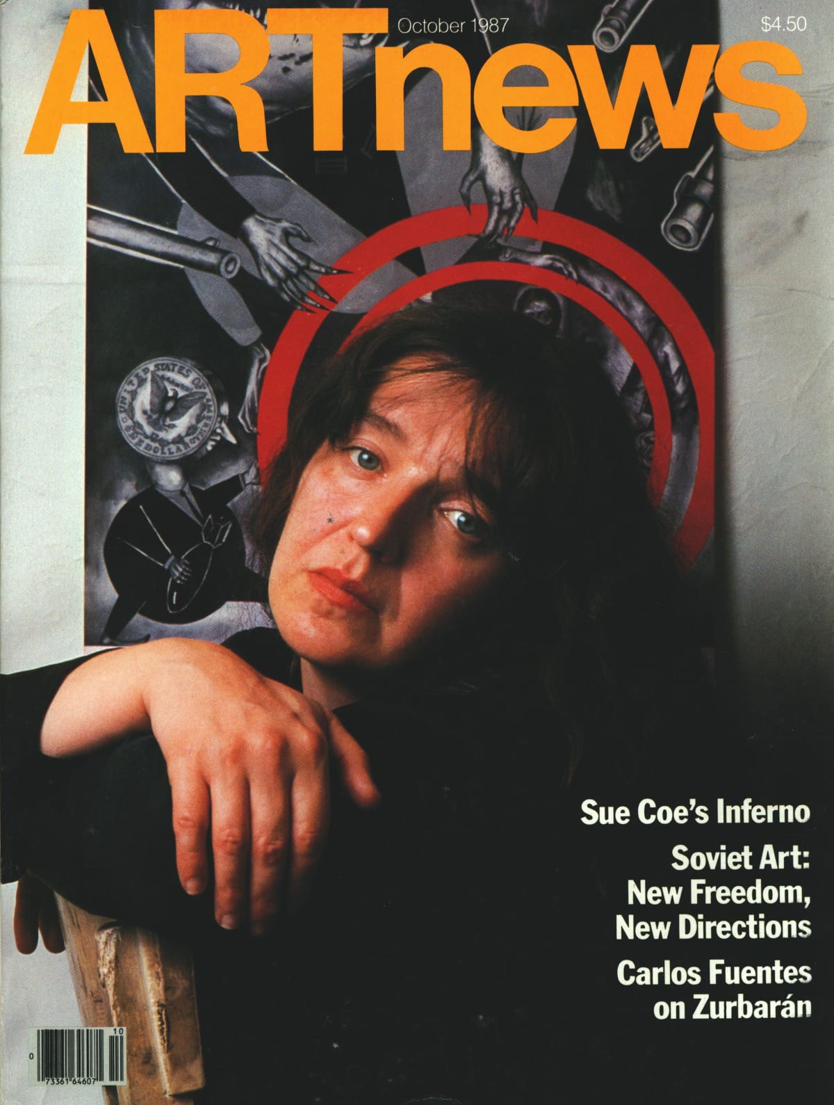 Photograph of Sue Coe on the cover of Art News. She sits on a chair, leaning forward, looking out at the viewer; behind her is her artwork